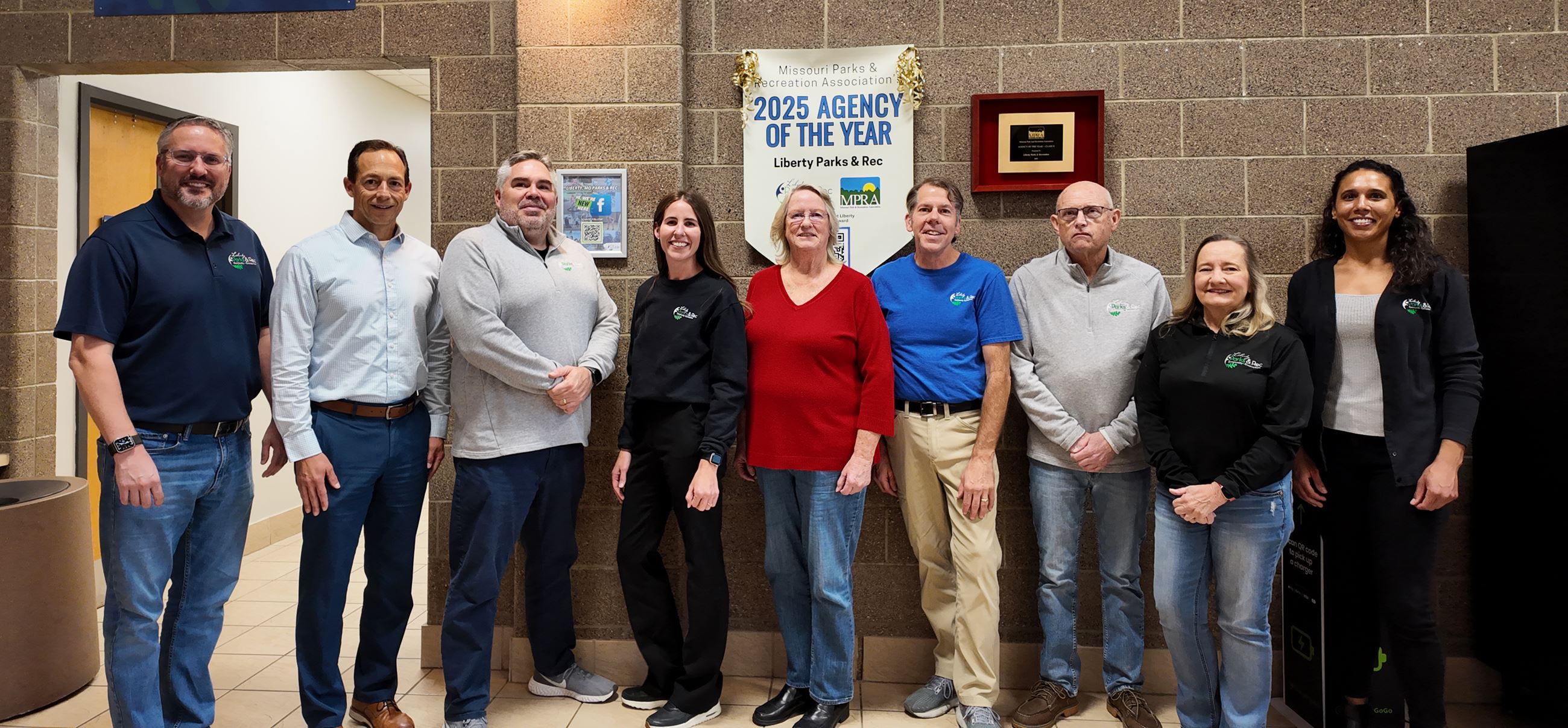 All 9 members of the 2025 park board standing in the Liberty Community Center lobby