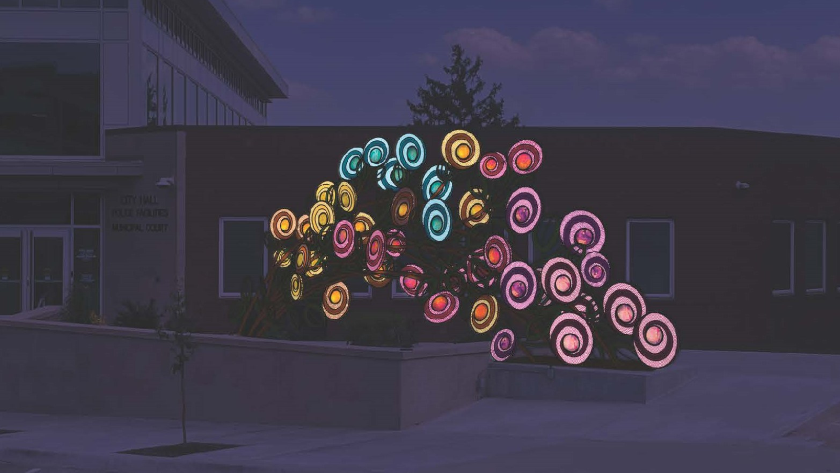 Photo of the Commissioned Sculpture at Night which is a giant rose bush